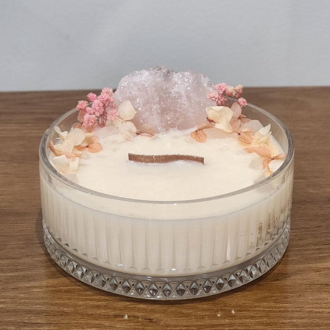 Candle with decorative elements on a wooden surface